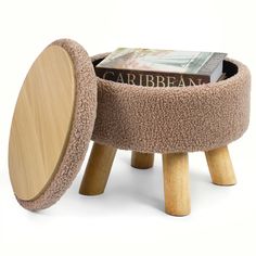 a wooden stool with a book in it and a magazine on the top of it