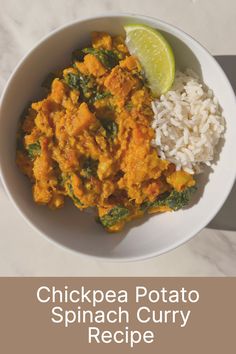 chicken and spinach curry recipe in a white bowl with rice, lime wedge on the side