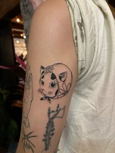 a person with a cat tattoo on their arm