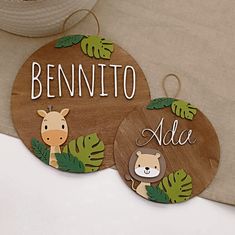 two wooden signs with animals and leaves on them that say, benito ade