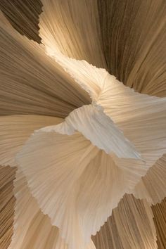 the ceiling is made up of many different shades of white and brown paper, as well as an intricate design