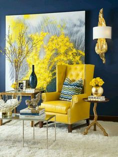 a living room with blue walls and yellow chairs in the corner, paintings on the wall