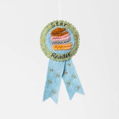 a blue ribbon hanging from the side of a badge with an image of a hamburger on it