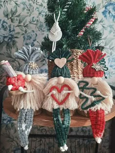 three knitted christmas decorations sitting on top of a chair