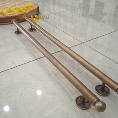 three metal bars on the floor with flowers