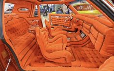 the interior of an orange car is shown