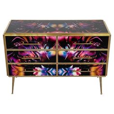 a multicolored chest of drawers with metal handles and two drawers on each side