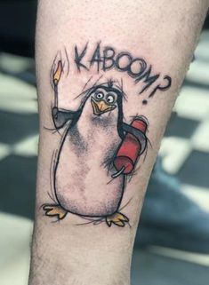 a penguin with a candle in its hand and the word kaboom written on it