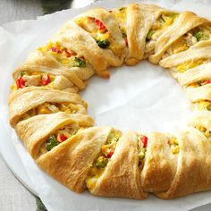 a white plate topped with a pastry covered in cheese and veggies