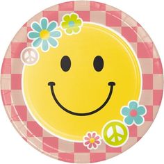 a paper plate with a smiley face and flowers on it