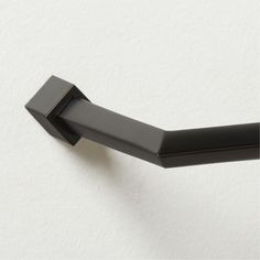 a black handle on a white wall