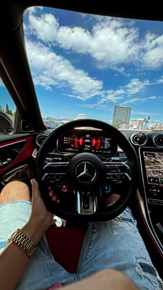 a man driving a car with his feet on the steering wheel