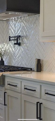 a kitchen with white cabinets and an oven