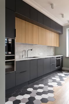 Create a sleek and stylish kitchen with this minimalist modern design. Featuring black and white floor tiles, walls, cabinets, and counters, this kitchen is the perfect blend of form and function.