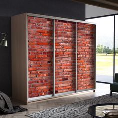 a living room with a brick wall and sliding glass doors