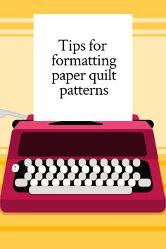 a red typewriter sitting on top of a table next to a white sign that says tips for formating paper quilt patterns