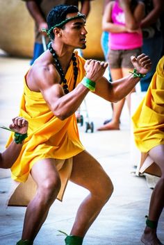 a man in yellow is dancing with other people