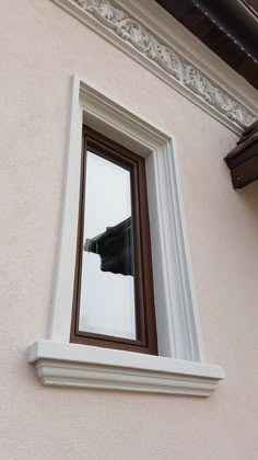 a window with a reflection of a black cat in it's panoramic windowsill