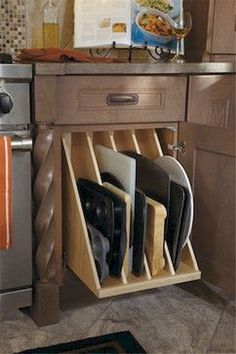 a kitchen cabinet with utensils in it