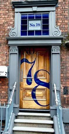 an entrance to a building with stairs leading up to it and a sign on the door that says no 78