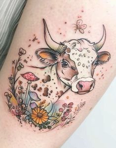 a cow with flowers and butterflies on it's thigh