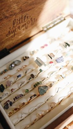 an open wooden box filled with lots of jewelry