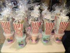 popcorn cups are wrapped in plastic bags and ready to be used as candy bar favors