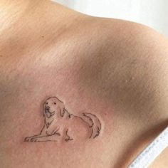 a dog tattoo on the back of a woman's shoulder