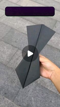 someone is holding an origami piece in their hand and pointing it towards the camera