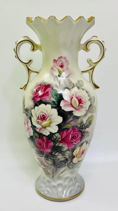 a white vase with flowers painted on it