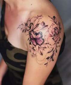 a woman with a butterfly and flowers tattoo on her shoulder