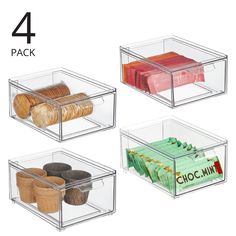 four clear bins with different types of cookies and chocolates in each one, all stacked on top of each other