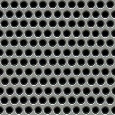 an image of a metal surface with holes in the center and black circles on it