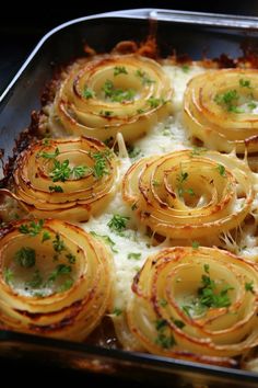 a casserole dish with onions and parmesan cheese on top, ready to be eaten