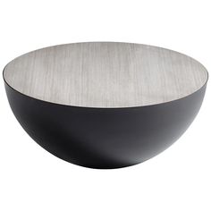 a black and silver bowl sitting on top of a table