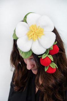 a woman with long hair wearing a flower and fruit headband