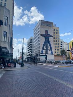 a large mural of a man riding a bike on the side of a tall building