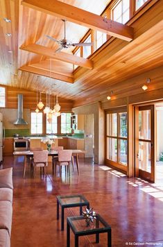 a living room filled with furniture and lots of windows