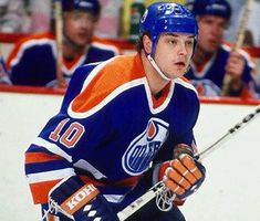 an image of a man playing hockey on the ice in front of other players and fans