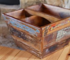 a wooden box sitting on top of a wooden table