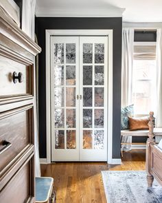 a bedroom with black walls and white doors