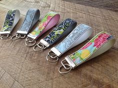 four key fobs are lined up on a table