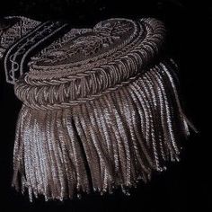 a close up of a necklace on a mannequin's neck with fringes