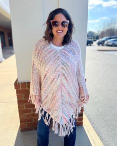 Wrap yourself in the cozy comfort of our Jane Fringe Poncho. It’s a stunning cable knit cape, accented with a vibrant multi-color fringe detail that unarguably stands out. This pullover is not just a stylish accessory, it's an experience of unmatched warmth and comfort. The poncho features a loose fit design to keep you at ease throughout the day, making it an excellent choice for those chilly days and cool nights. The multi-color fringe detailing adds a playful pop of color to the subdued cable Winter Multicolor Poncho With Tassels, Cozy Multicolor Poncho, Multicolor Tassel Poncho For Winter, Cozy Multicolor Poncho For Fall, Cozy Multicolor Fall Poncho, Multicolor Knit Poncho For Fall, Pink One-size Poncho For Fall, Cozy Pink Poncho For Fall, Pink One Size Poncho For Fall