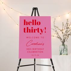 a pink sign that says hello thirty welcomes someone's 30th birthday celebration