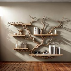 a tree shelf with books and vases on it in front of a white wall