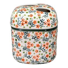 an orange and green flowered container on a white background, with the lid closed