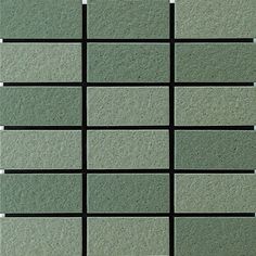 several square tiles are arranged in rows on the wall, one is green and the other is black