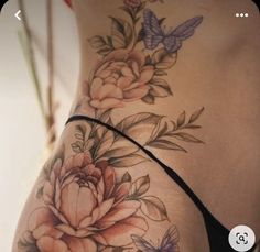 a woman's stomach with flowers and butterflies on it