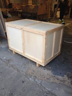 a large wooden box sitting on top of a floor